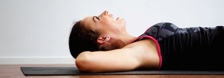 Chiropractic Roswell GA Woman Stretching On Mat